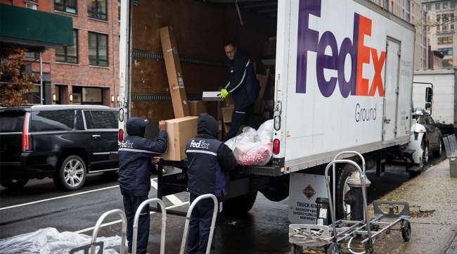 FedEx workers unload package
