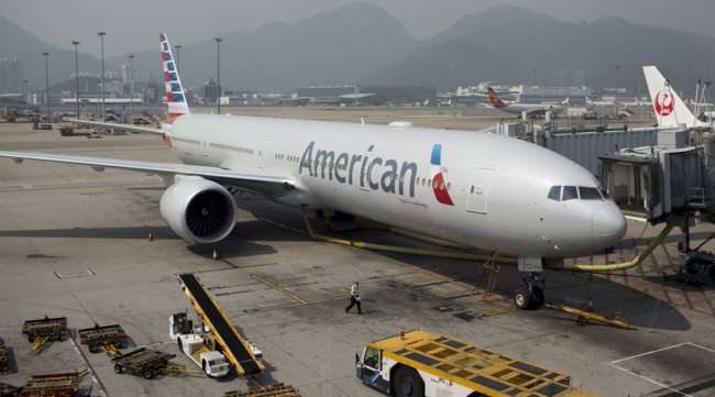 An American Airlines Boeing 777-300 sits parked at Hong Kong International Airport in June 2014.