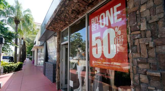 A business displays a sale sign in Surfside, Fla., on Oct. 12.