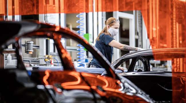 A worker checks a paint finish on the production line inside a Mercedes-Benz plant in Hungary on May 7.