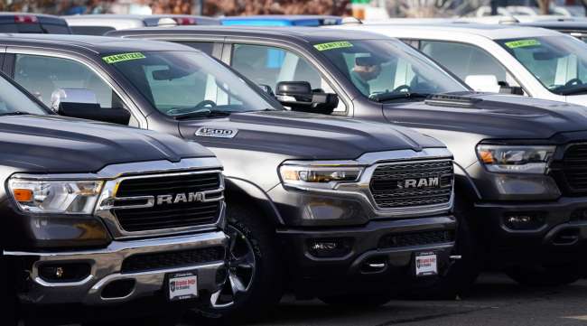 A row of unsold 2020 pickup trucks sits at a Ram dealership in Colorado in December 2020. (David Zalubowski/Associated Press)
