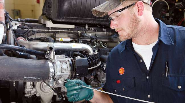 Shell technician checks engine oil