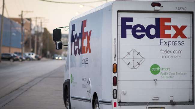 A FedEx Express truck makes deliveries