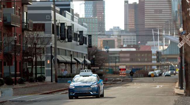 A test vehicle from Argo AI, Ford's autonomous vehicle unit, navigates a street in Pittsburgh.