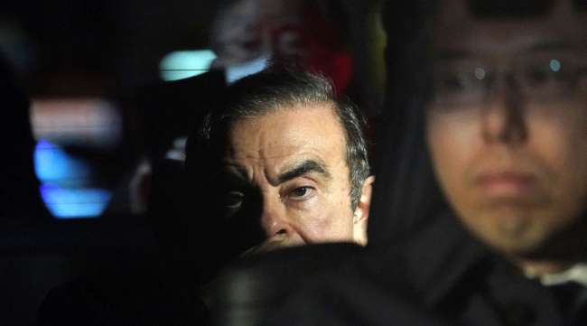 Charles Ghosn sits in a vehicle as he leaves his lawyer's office in Tokyo, Japan, in March 2019.