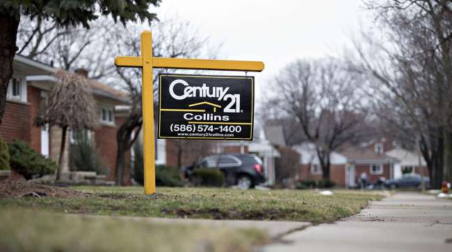 Century 21 Real Estate signage is displayed outside a home for sale in St. Clair Shores, Mich.