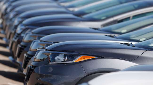 A long row of unsold cars sits at a Honda dealership in Colorado June 7