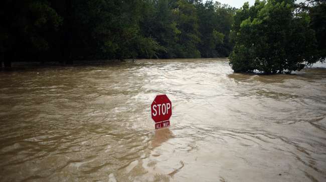 A "Stop" sign stands in floodwaters due to Hurricane Harvey in Spring, Texas, U.S., on Monday, Aug. 28, 2017.;