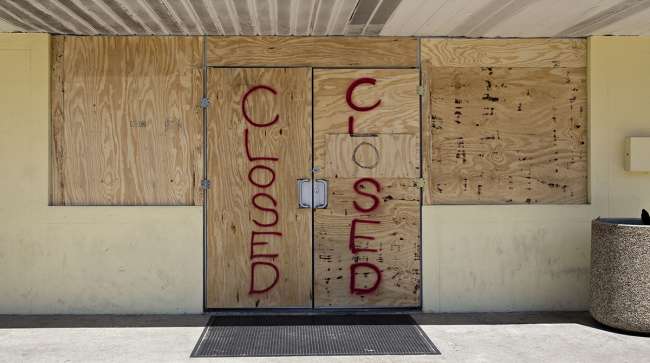 Plywood covers the doors of a 7-Eleven Inc. store ahead of Hurricane Irma in Madeira Beach, Fla.