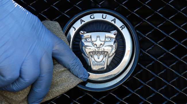 Hand polishing Jaguar logo