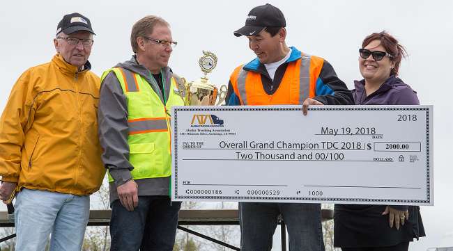 Alaska Grand Champion Ryan Wolcoff holds winner's check