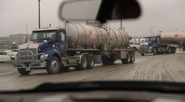 Trucks leave the MarkWest Energy plant in Cadiz, Ohio, on Feb. 25.