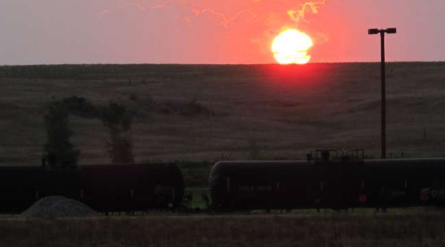A freight trail full of tanker cars hauling crude oil crosses the plains near Trenton, N.D.