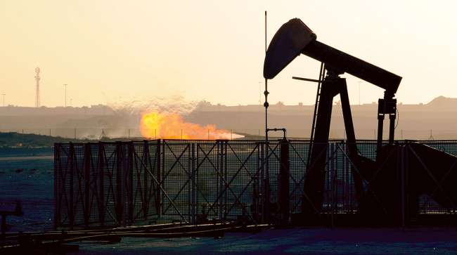 An oil pump operates in an oil field in Awali, Bahrain