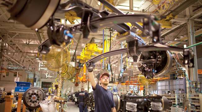 A line worker checks an axle at Volvo's New River Valley Plant in Dublin, Va.