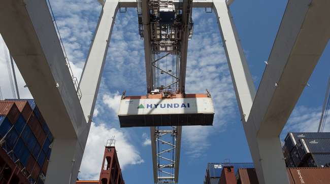 A container is loaded onto a ship at the Port of Savannah in Savannah, Ga.