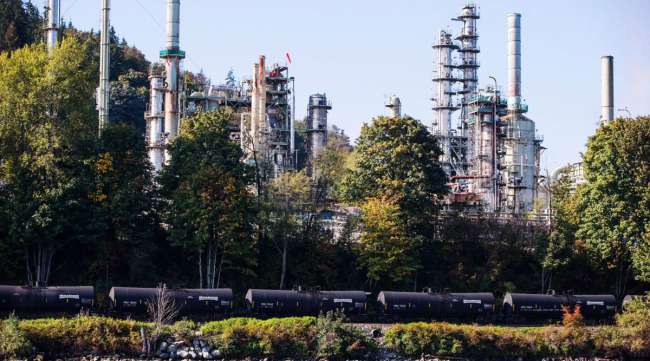A Canadian Pacific Rail locomotive pulls oil tankers past a refinery in Burnaby, British Columbia, in September 2018.