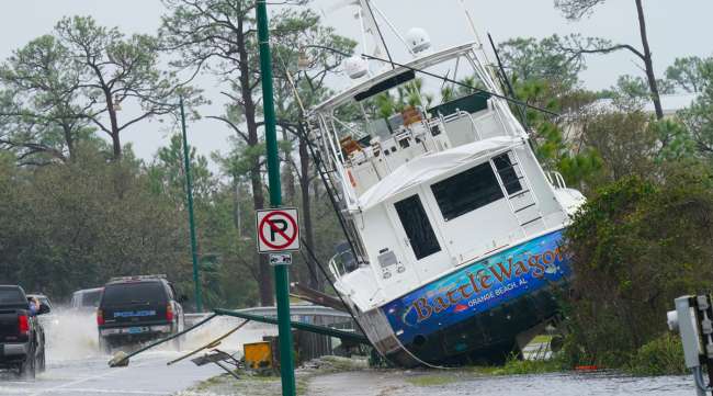 A boat is washed up near a road in Orange Beach, Ala., on Sept. 16.