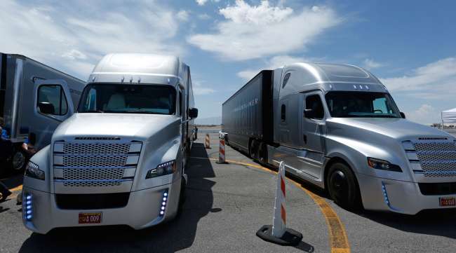 People load into a Daimler Freightliner Inspiration self-driving truck for a demonstration in 2015.