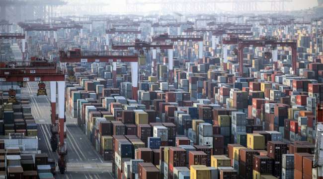 Shipping containers sit next to gantry cranes at the Yangshan Deepwater Port in Shanghai, China, on Jan. 11.