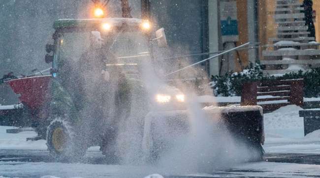 Worker clears snow from New York City street