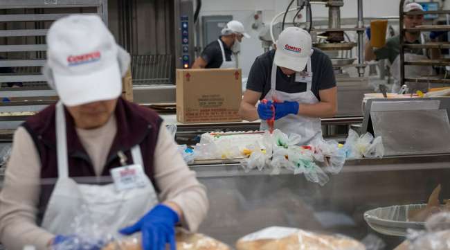 Employees work in the bakery department of a Costco store in San Francisco.
