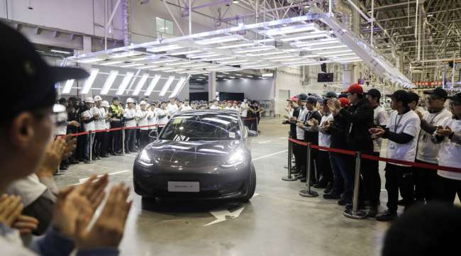 A Tesla Model 3 moves off an assembly line during a ceremony at the company's Gigafactory in Shanghai in 2019.