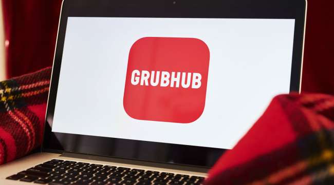The logo for the Grubhub app shows on a laptop.