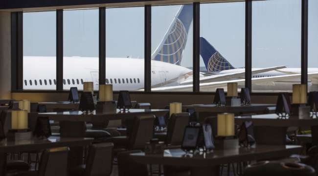United Airlines planes stand past an empty waiting area for travelers at Newark International Airport in New Jersey.