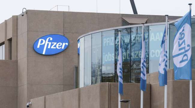 A Pfizer office in Puurs, Belgium, shows a hiring poster in a window on Nov. 10.