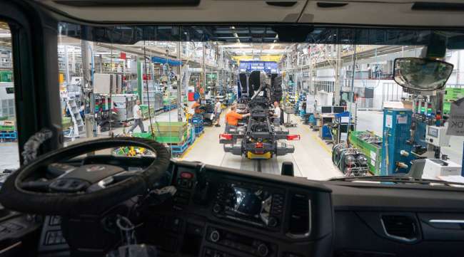 Employees work on a truck chassis assembly line in Netherlands.