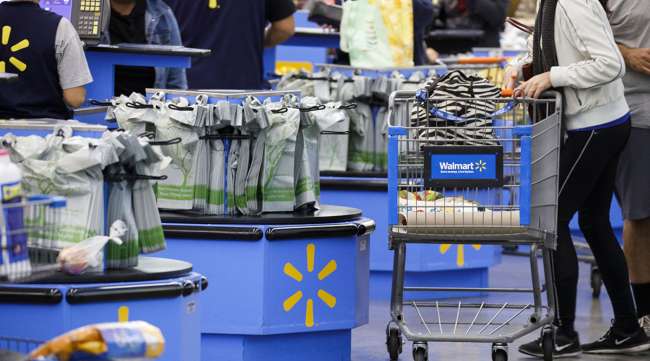 A customer pushes a shopping cart after at a Walmart Inc. store in Burbank, Calif.