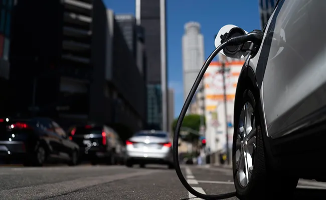 An electric vehicle is plugged into a charger 