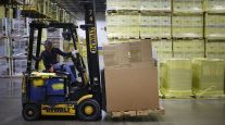 A warehouse worker operates a forklift