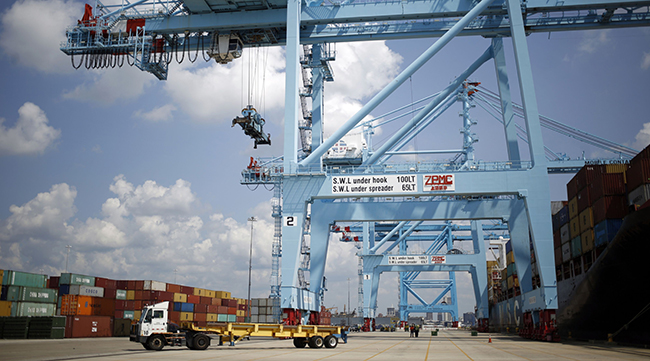 Gantry cranes stand in the APM Terminals yard at the Port of Mobile