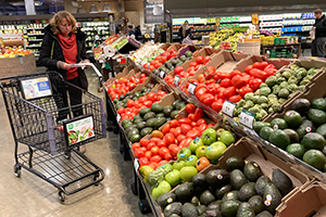 Shoppers pick out items at a grocery store
