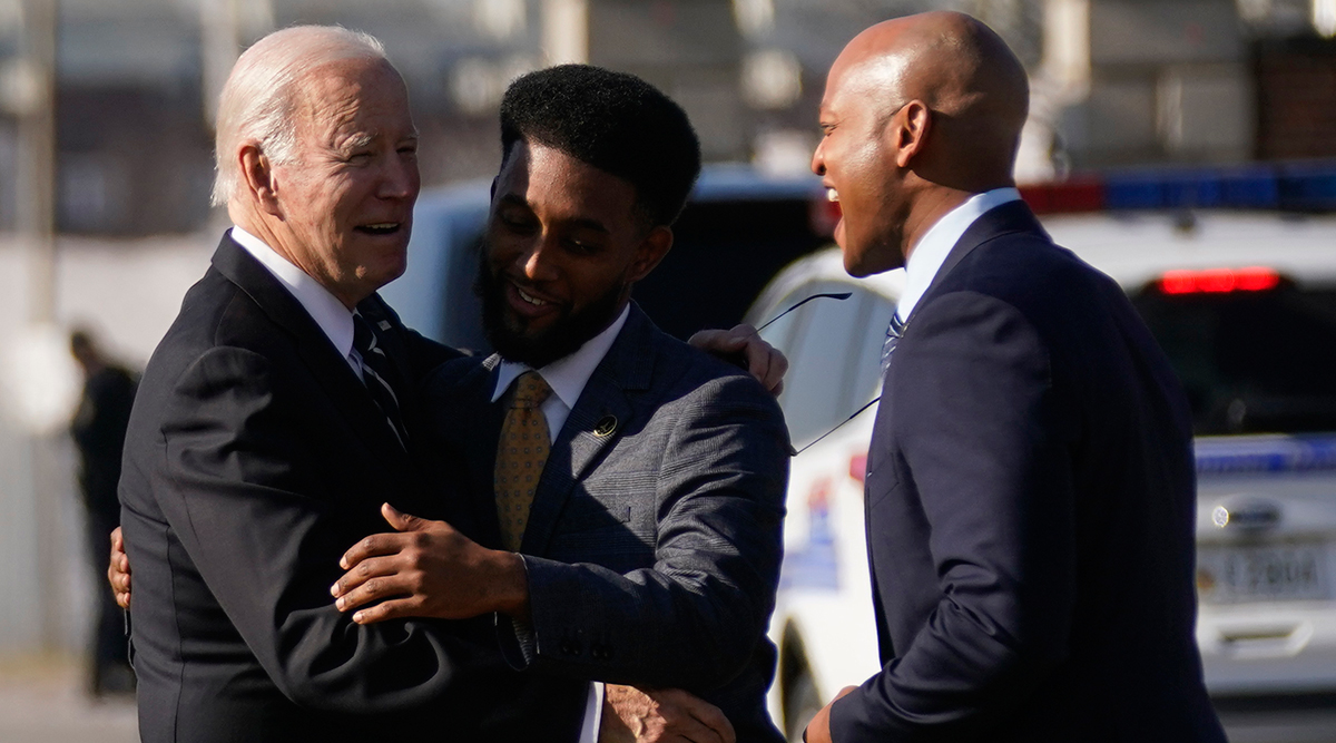 President Joe Biden greets Baltimore Mayor Brandon Scott and Maryland Gov. Wes Moore