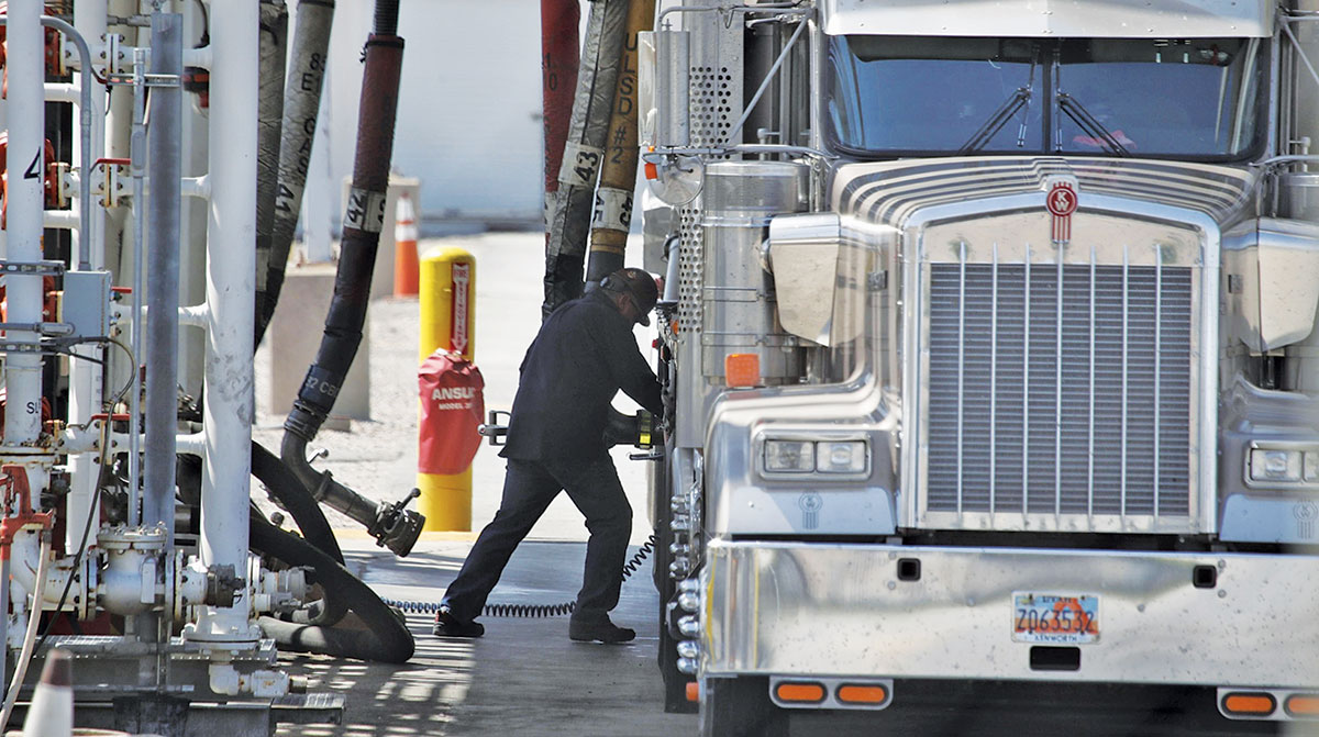 Driver fueling truck