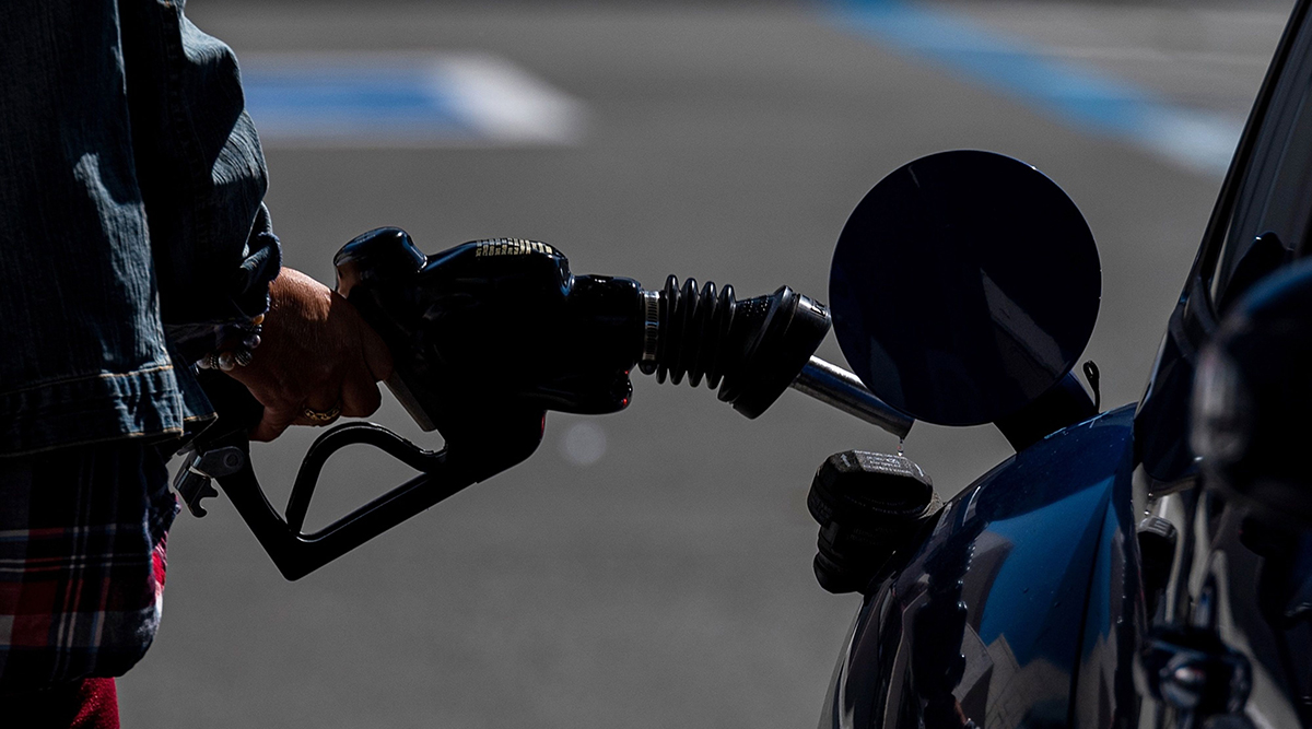 A person holds a fuel pump nozzle