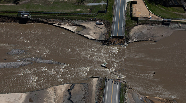 A road collapsed due to flood water after dams failed in Midland, Mich.