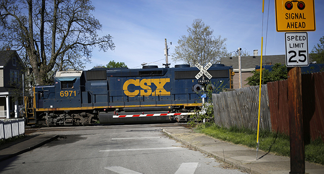 A CSX train at a railroad crossing in Covington, Ky.