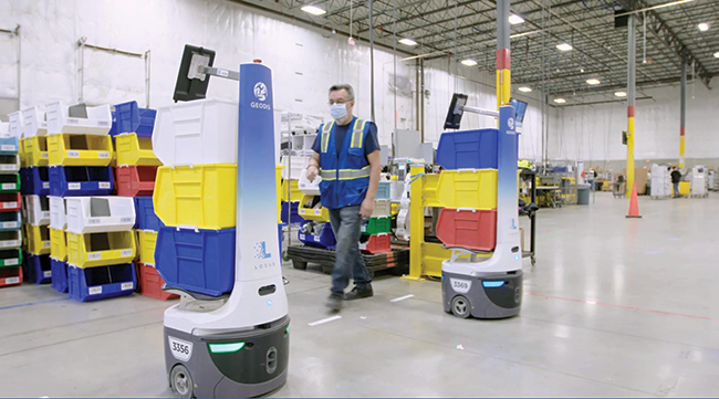 Warehouse robots from Locus Robotics transport goods inside a Geodis facility