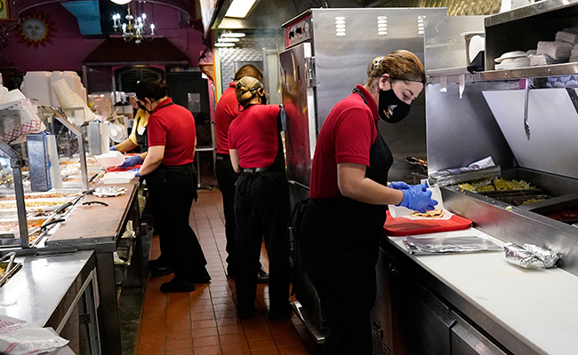 Employees work at a restaurant in Chicago