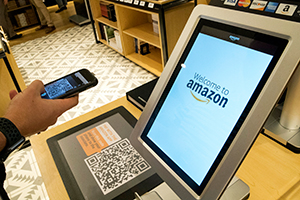 A customer uses the Amazon app to pay for his purchase at an Amazon store in New York
