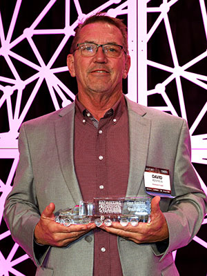 Dave Renfrew of Roadrunner poses with his 2022 Recruiter of the Year award.