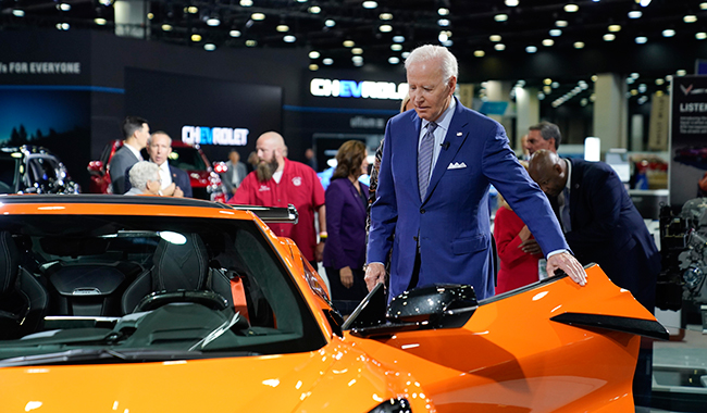 President Joe Biden gets into a Corvette during a tour of the auto show in Detroit