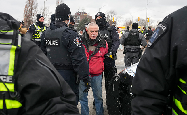 A protester is arrested by police in Windsor Feb. 13. 
