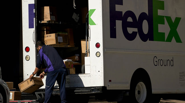 A FedEx worker unloads a truck in downtown Dallas, Texas.