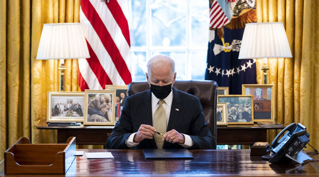 President Biden signs the Paycheck Protection Program Act in the Oval Office on March 30.