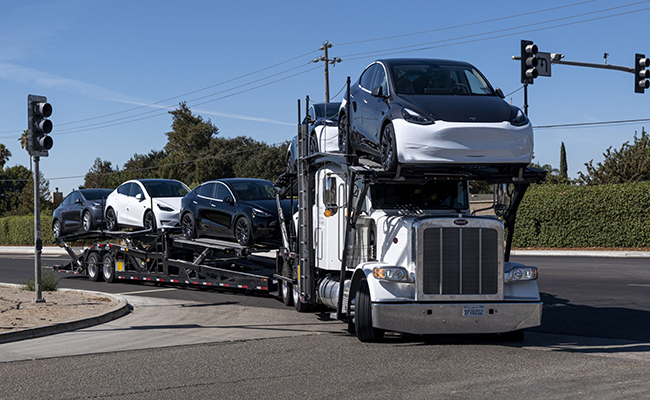An auto carrier transports Tesla vehicles in Lathrop, Calif.